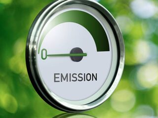Gauge with inscription EMISSION. Arrow points to zero. Concept of green energy.